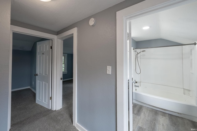 1201 Canal St, New Haven, IN 46774 - bathroom with shower / bath combination, vaulted ceiling, and wood finished floors