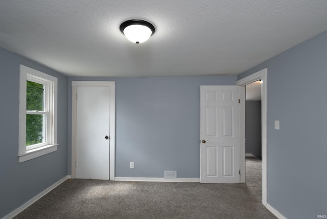 1201 Canal St, New Haven, IN 46774 - unfurnished bedroom featuring carpet, a textured ceiling, and a closet