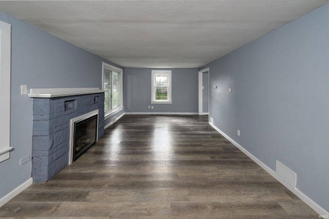 1201 Canal St, New Haven, IN 46774 - unfurnished living room featuring a glass covered fireplace and dark wood-style floors