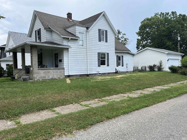 946 S 23rd St, South Bend, IN 46615 - traditional-style house featuring a shingled roof, a front yard, a chimney, a porch, and a garage