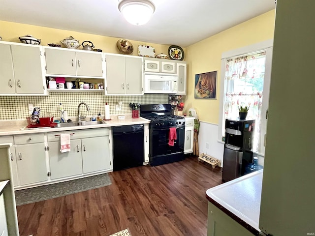 946 S 23rd St, South Bend, IN 46615 - kitchen featuring black appliances, dark wood-style flooring, light countertops, and decorative backsplash