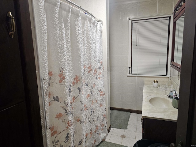 922 21st St, Logansport, IN 46947 - bathroom with tile patterned flooring, vanity, curtained shower, and tile walls