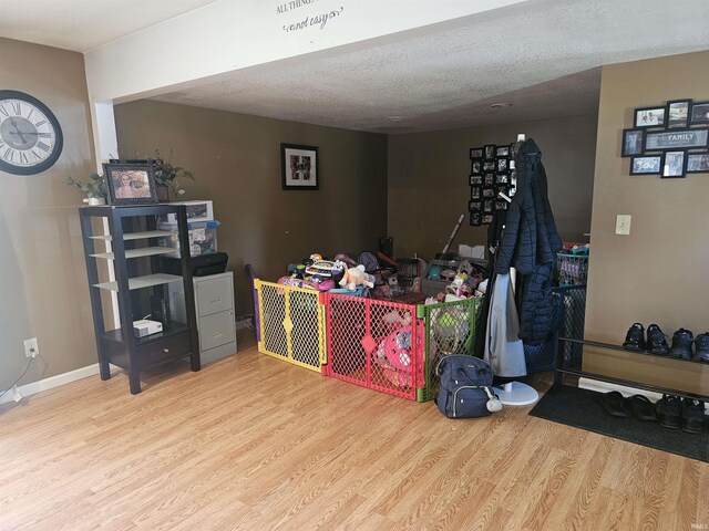 922 21st St, Logansport, IN 46947 - recreation room featuring wood finished floors and a textured ceiling