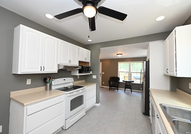 418 W 7th St, Rochester, IN 46975 - kitchen featuring white range with electric cooktop, freestanding refrigerator, under cabinet range hood, white cabinetry, and recessed lighting