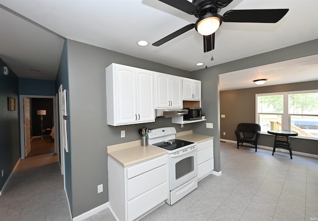 418 W 7th St, Rochester, IN 46975 - kitchen featuring white electric stove, light countertops, white cabinetry, ceiling fan, and light tile patterned floors