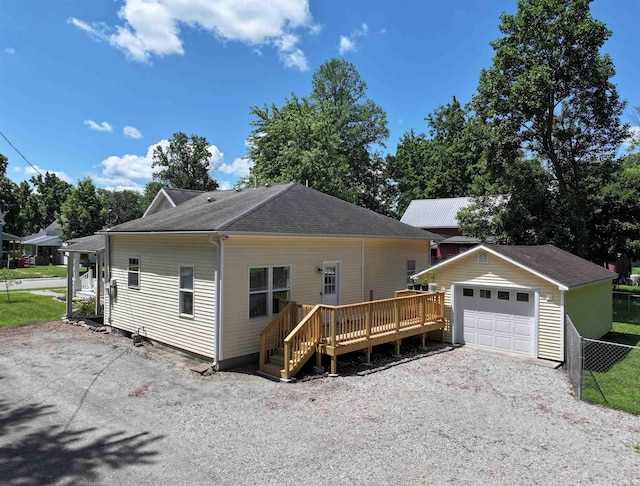 418 W 7th St, Rochester, IN 46975 - view of front of home with a wooden deck, an outdoor structure, a garage, driveway, and roof with shingles