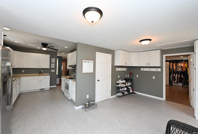 418 W 7th St, Rochester, IN 46975 - kitchen featuring white electric stove, stainless steel fridge, white cabinetry, ceiling fan, and light tile patterned flooring