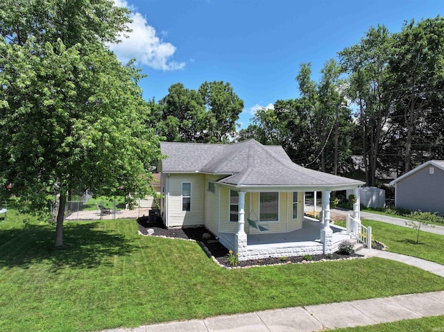 418 W 7th St, Rochester, IN 46975 - view of front of house with covered porch, a front lawn, and a shingled roof