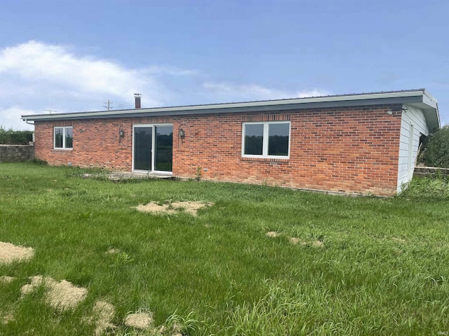 4524 E 800 N, Ossian, IN 46777 - rear view of house featuring a yard, brick siding, and a metal roof