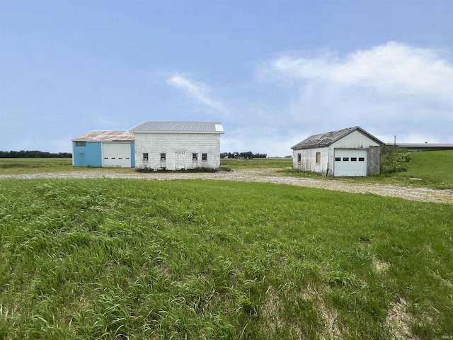 4524 E 800 N, Ossian, IN 46777 - view of side of home with an outbuilding, a lawn, a detached garage, and a pole building