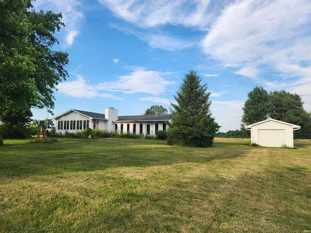 8276 N 100th Rd, Uniondale, IN 46791 - view of green lawn with a garage and a storage shed
