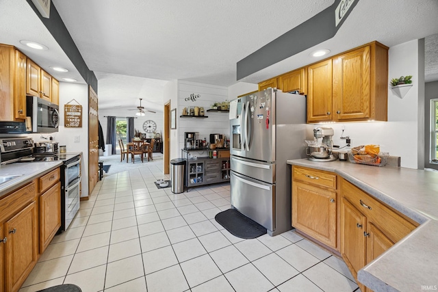 12856 W Bicycle Bridge Rd, Battle Ground, IN 47920 - kitchen with stainless steel appliances, light tile patterned floors, ceiling fan, light countertops, and recessed lighting