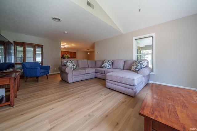 830 W Walnut Rdg, Logansport, IN 46947 - living room featuring light wood finished floors and vaulted ceiling
