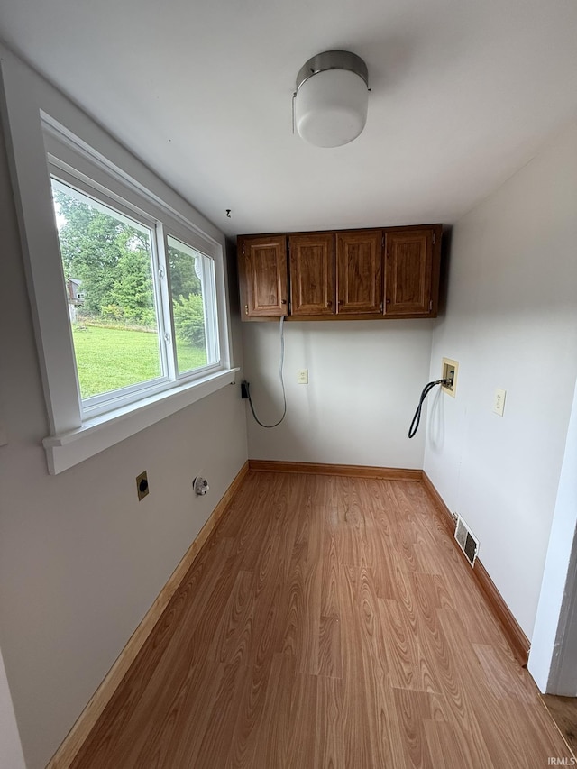903 W Temperance St, Ellettsville, IN 47429 - laundry area featuring cabinet space, electric dryer hookup, light wood finished floors, and hookup for a washing machine