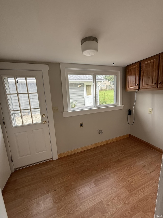 903 W Temperance St, Ellettsville, IN 47429 - laundry room featuring cabinet space, electric dryer hookup, and light wood finished floors