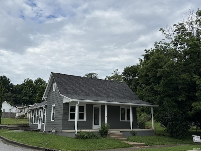 903 W Temperance St, Ellettsville, IN 47429 - view of front facade featuring a porch, roof with shingles, and a front yard