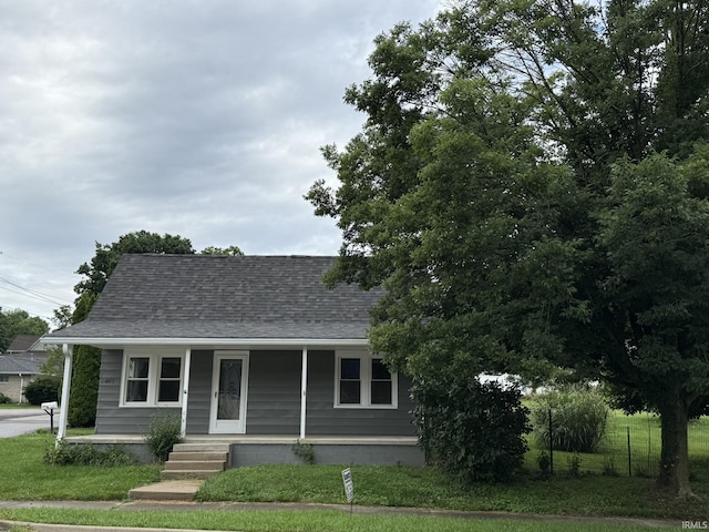 903 W Temperance St, Ellettsville, IN 47429 - view of front of home featuring a porch, roof with shingles, and a front yard