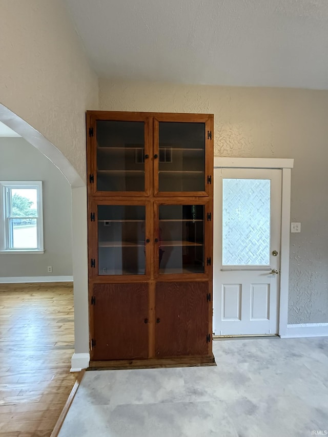 903 W Temperance St, Ellettsville, IN 47429 - unfurnished dining area featuring a textured wall and baseboards