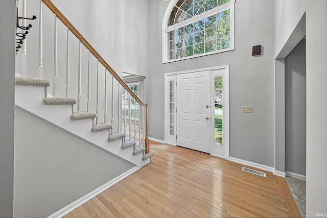 14276 Old Pine Ln, Mishawaka, IN 46545 - foyer entrance featuring plenty of natural light, a towering ceiling, stairs, and hardwood / wood-style floors