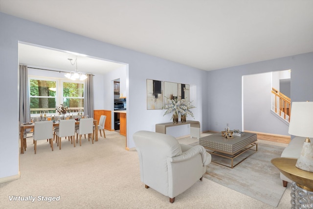 26247 Douglas Ave, Elkhart, IN 46514 - living area featuring carpet floors, stairs, and a chandelier