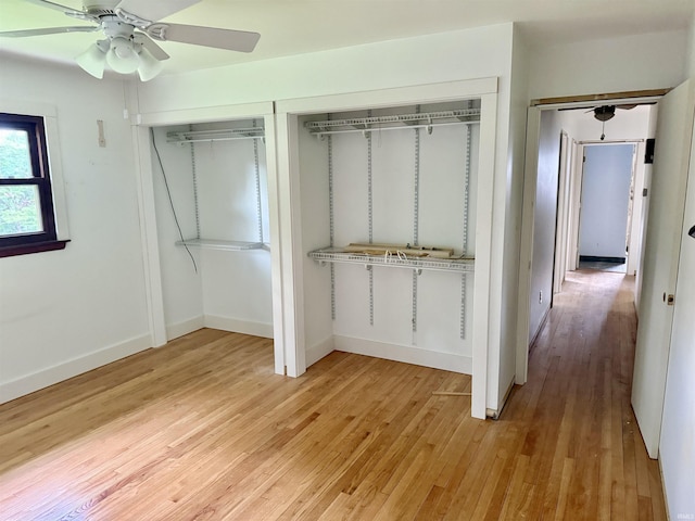 1417 E Clairmont Pl, Bloomington, IN 47401 - unfurnished bedroom with light wood-style floors, a ceiling fan, and multiple closets