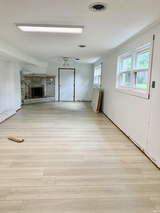 1417 E Clairmont Pl, Bloomington, IN 47401 - unfurnished living room featuring a fireplace, light wood finished floors, and ceiling fan