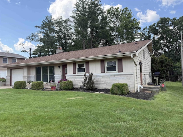 1417 E Clairmont Pl, Bloomington, IN 47401 - ranch-style house featuring stone siding, a garage, a front yard, a chimney, and roof with shingles