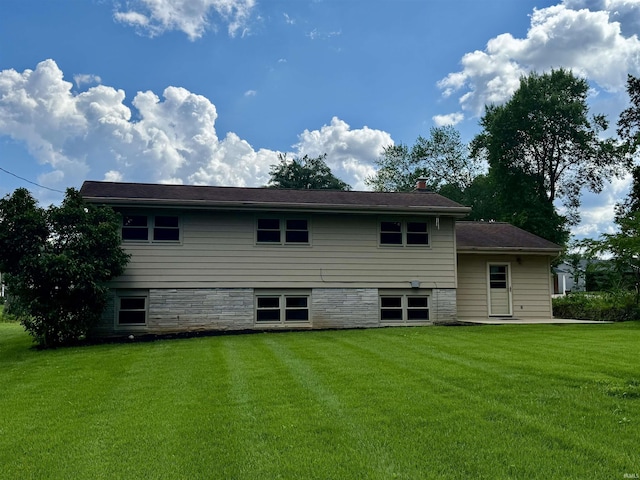 1417 E Clairmont Pl, Bloomington, IN 47401 - rear view of property with a yard and a chimney