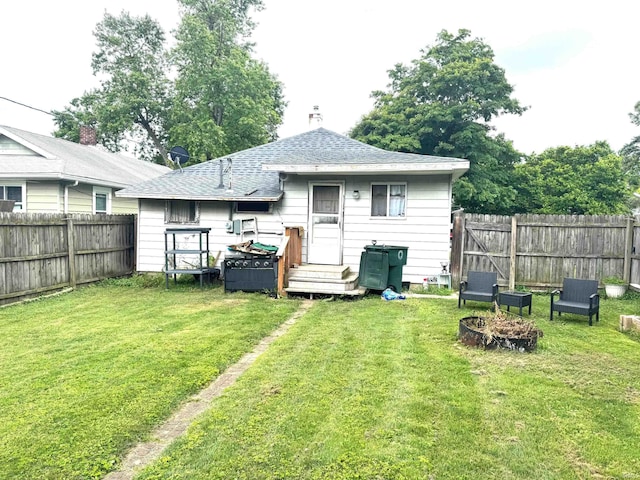 2306 S Mulberry St, Muncie, IN 47302 - back of property featuring a fenced backyard and roof with shingles