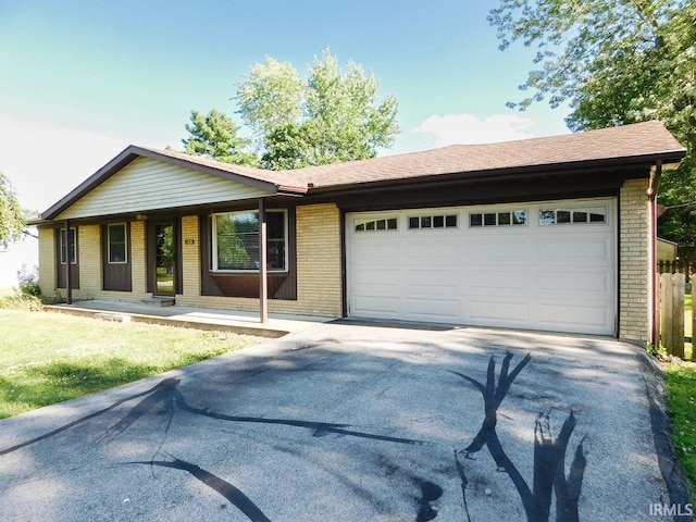 185 W Mercury St, Markle, IN 46770 - ranch-style house with brick siding, driveway, an attached garage, and covered porch