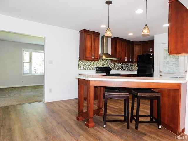 185 W Mercury St, Markle, IN 46770 - kitchen featuring black appliances, wall chimney exhaust hood, light countertops, tasteful backsplash, and recessed lighting