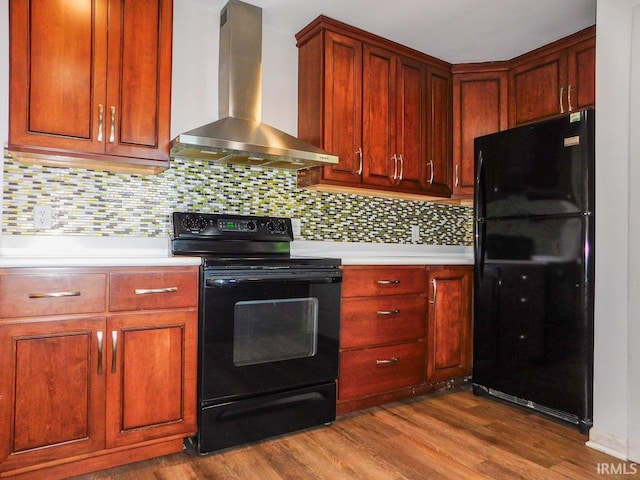 185 W Mercury St, Markle, IN 46770 - kitchen with black appliances, wall chimney range hood, light countertops, dark wood-style floors, and tasteful backsplash