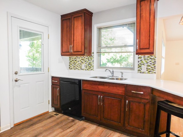 185 W Mercury St, Markle, IN 46770 - kitchen with black dishwasher, backsplash, light wood-style flooring, and light countertops