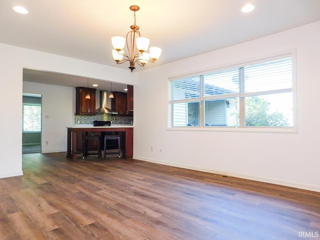 185 W Mercury St, Markle, IN 46770 - kitchen featuring wall chimney range hood, dark wood-style floors, a chandelier, recessed lighting, and hanging light fixtures