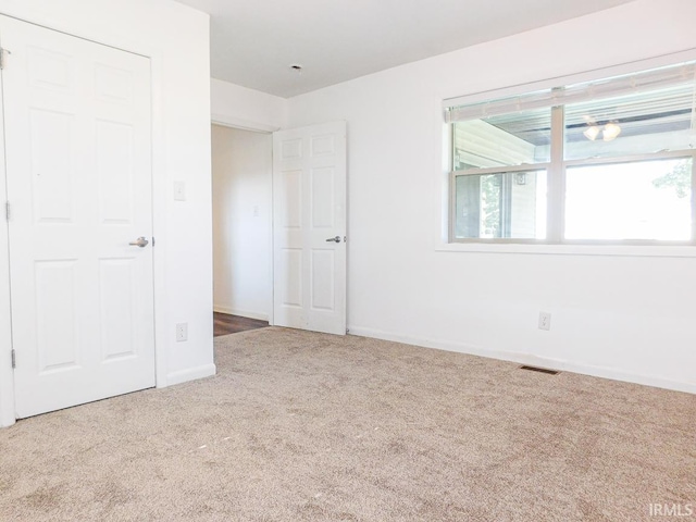185 W Mercury St, Markle, IN 46770 - unfurnished bedroom featuring carpet floors and multiple windows