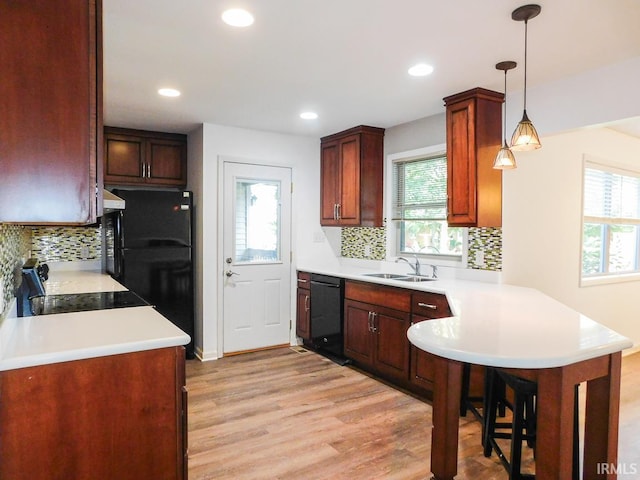185 W Mercury St, Markle, IN 46770 - kitchen featuring black appliances, a peninsula, plenty of natural light, light wood-type flooring, and recessed lighting