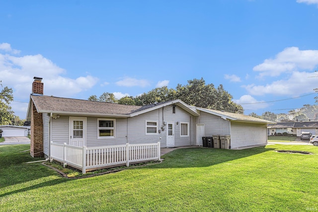 3303 Hilltop Dr, South Bend, IN 46614 - rear view of property featuring a chimney, a yard, and roof with shingles