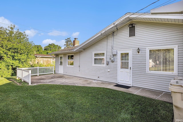 3303 Hilltop Dr, South Bend, IN 46614 - back of house with a yard, a patio, and a chimney