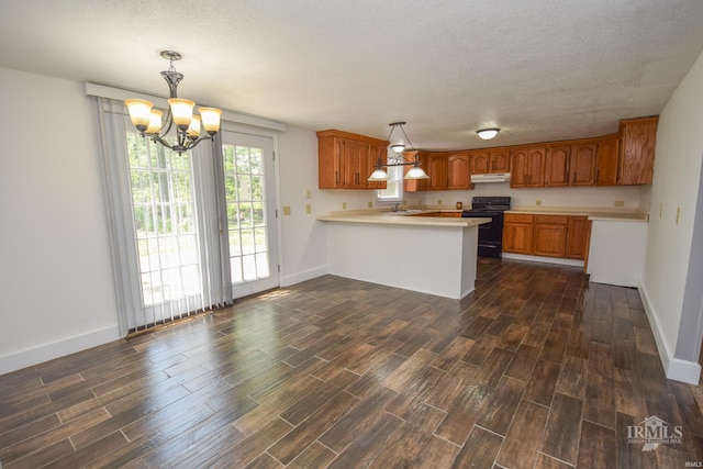 4044 S Younkin Dr, Redkey, IN 47373 - kitchen with black / electric stove, a peninsula, light countertops, a chandelier, and a textured ceiling