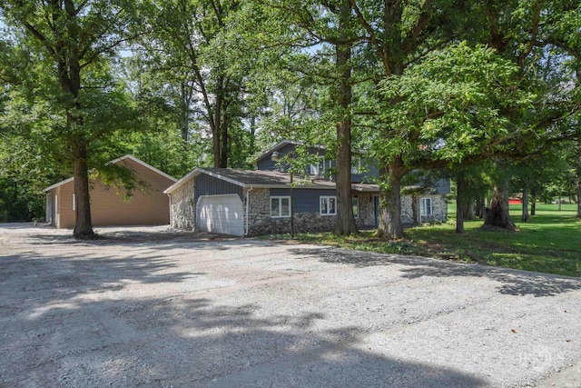 4044 S Younkin Dr, Redkey, IN 47373 - view of front of property with stone siding, asphalt driveway, and an attached garage