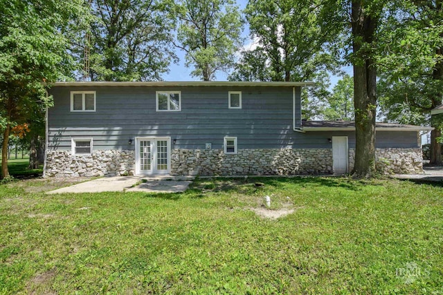 4044 S Younkin Dr, Redkey, IN 47373 - rear view of property with stone siding, a patio area, a lawn, and french doors