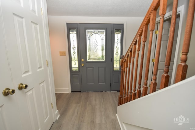 4044 S Younkin Dr, Redkey, IN 47373 - entrance foyer featuring wood finished floors, stairway, and a textured ceiling