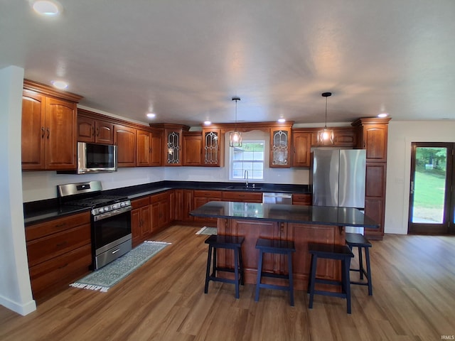 1578 E 100 N, Washington, IN 47501 - kitchen featuring appliances with stainless steel finishes, light wood-style flooring, a breakfast bar area, dark countertops, and recessed lighting