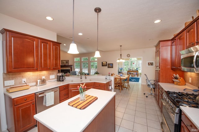 344 Rosebank Ln, West Lafayette, IN 47906 - kitchen with stainless steel appliances, a peninsula, tasteful backsplash, light countertops, and a center island
