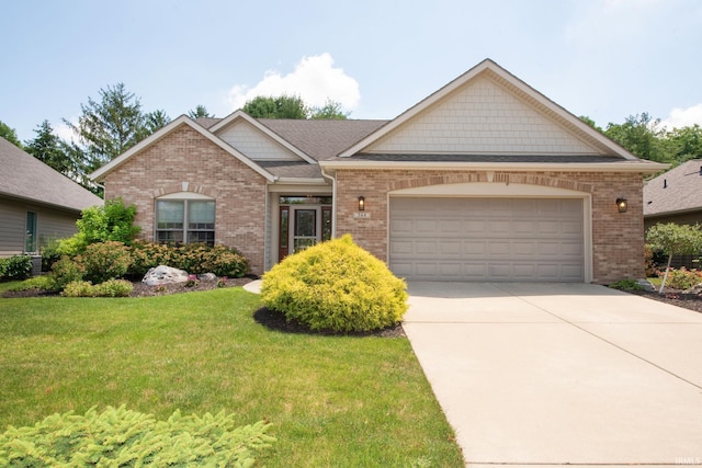 344 Rosebank Ln, West Lafayette, IN 47906 - view of front of house featuring an attached garage, a front lawn, brick siding, and driveway
