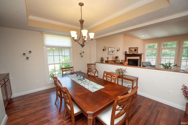 344 Rosebank Ln, West Lafayette, IN 47906 - dining space with dark wood finished floors, a chandelier, a tile fireplace, crown molding, and a tray ceiling