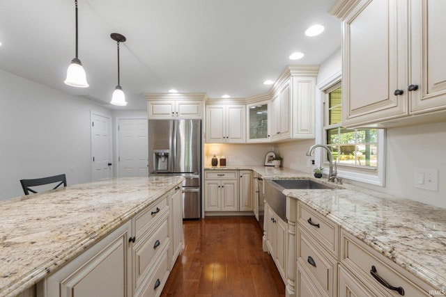1704 S Sutton Circle Dr, Bluffton, IN 46714 - kitchen with stainless steel refrigerator with ice dispenser, cream cabinets, light stone counters, dark wood-style flooring, and recessed lighting