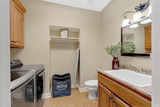 1669 E Brookside Trl, Columbia City, IN 46725 - bathroom featuring separate washer and dryer, vanity, and tile patterned flooring