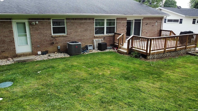 6970 S Maple St, Marion, IN 46953 - back of property featuring brick siding, a deck, a yard, and roof with shingles
