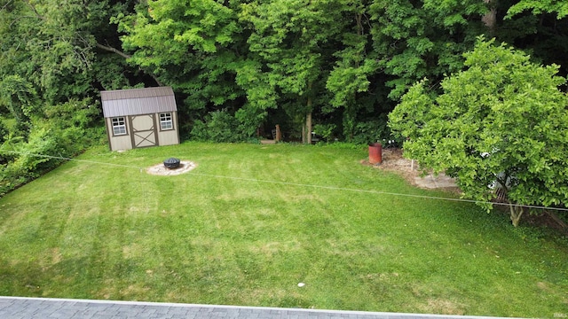6970 S Maple St, Marion, IN 46953 - view of green lawn featuring a storage unit and a fire pit